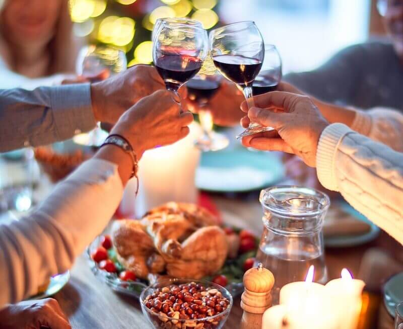 woman in white long sleeve shirt holding wine glass