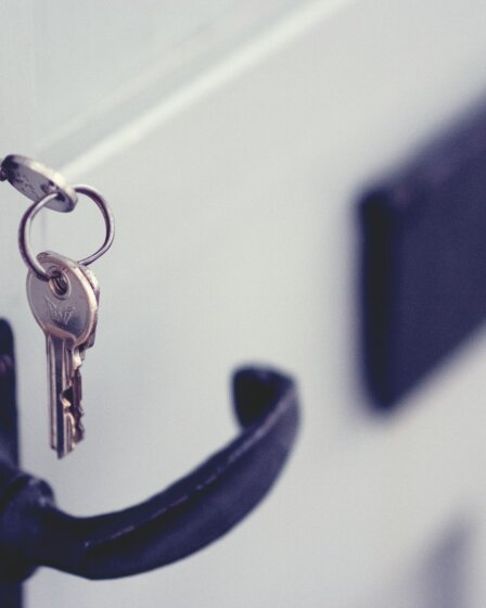 black and silver padlock on white door