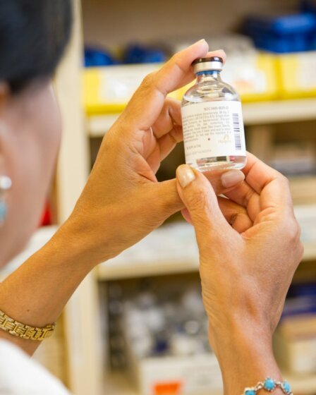 person holding white labeled bottle