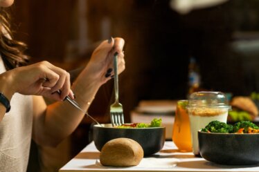 person holding silver fork and knife