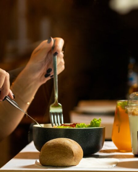 person holding silver fork and knife