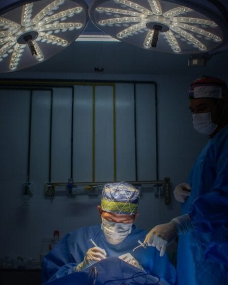 a group of doctors in scrubs in a dark room